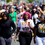 People march to the scene of a shooting at a supermarket in Buffalo, N.Y., Sunday, May 15, 2022.