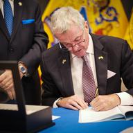 New Jersey Gov. Phil Murphy signs a bill requiring licensure for police. Social justice advocates say it's a welcome step, but they want more from the governor.