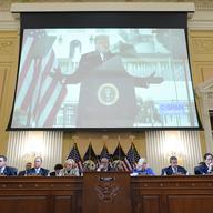 A video of former President Donald Trump speaking during a rally near the White House on Jan. 6, 2021, is shown as committee members look on, during a public hearing of the House select committee inve