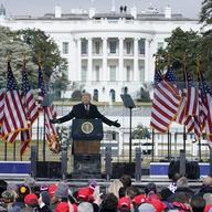 With the White House in the background, President Donald Trump speaks at a rally in Washington, Jan. 6, 2021. 