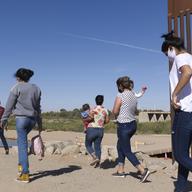 A group of Brazilian migrants make their way around a gap in the U.S.-Mexico border in Yuma, Ariz., seeking asylum in the U.S. after crossing over from Mexico, June 8, 2021. 