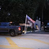 Supporters of former President Donald Trump drive past his Mar-a-Lago estate, Monday, Aug. 8, 2022, in Palm Beach, Fla. Trump said in a lengthy statement that the FBI was conducting a search of his Ma