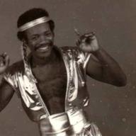 A singer dressed in flashy clothing, in an old black and white photo.