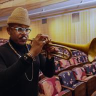 Photograph of a man holding a trumpet