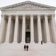 Justice Ketanji Brown Jackson, center left, is escorted by Chief Justice of the United States John Roberts following her formal investiture ceremony at the Supreme Court in Washington, Friday, Sept. 3