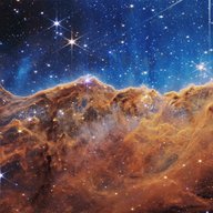 The image is divided horizontally by an undulating line between a cloudscape forming a nebula along the bottom portion and a comparatively clear upper portion. Speckled across both portions is a starf