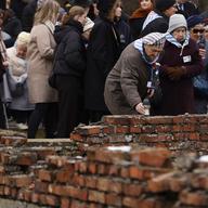 Holocaust survivors place candles at the former crematorium at the former Nazi German concentration and extermination camp Auschwitz during ceremonies marking the 78th anniversary of the liberation