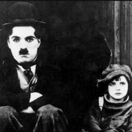  Publicity photo from Charlie Chaplin's 1921 movie The Kid. Pictured are Charlie Chaplin and Jackie Coogan.