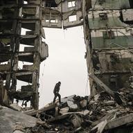 A resident looks for belongings in an apartment building destroyed during fighting between Ukrainian and Russian forces in Borodyanka, Ukraine, Tuesday, April 5, 2022.