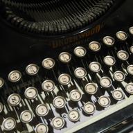 A Yiddish typewriter seen from above. The keys are circular.