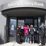 Security guards let individuals enter the Silicon Valley Bank's headquarters in Santa Clara, Calif., on Monday, March 13, 2023. 