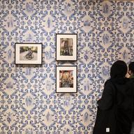 A photo of people looking at Jamel Shabazz work at the Museum of the City of New York
