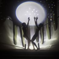 Shadow puppet silhouettes projected on an illuminated screen
