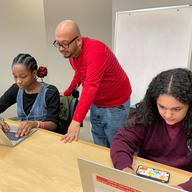 Belarmino Ortega (standing) created the Bronx Library Center Writer's Club.
