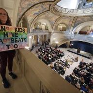Julia Williams holds a sign in counterprotest during a rally in favor of a ban on gender-affirming health care legislation, Monday, March 20, 2023, at the Missouri Statehouse in Jefferson City, Mo. 