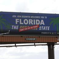 A new billboard welcoming visitors to 'Florida: The Sunshine 'Don't Say Gay or Trans' State. is seen Thursday, April 21, 2022, in Orlando, Fla.