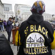 Eric McDonnell, Chair with the African American Reparations Advisory Committee, middle left, speaks at a reparations rally outside of City Hall in San Francisco, Tuesday, March 14, 2023.