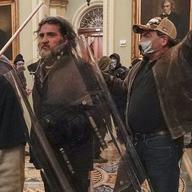 Rioters, including Dominic Pezzola, center with police shield, are confronted by U.S. Capitol Police officers outside the Senate Chamber inside the Capitol, Wednesday, Jan. 6, 2021, in Washington.