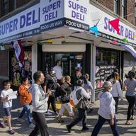 Parents and community members march through the residential neighborhood around P.S. 189 to protest New York City Mayor Eric Adam's plan to temporarily house immigrants in the school's gymnasium, Tues