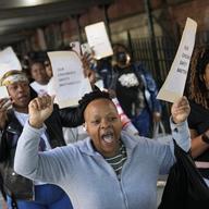 Parents and community members chant as they march around P.S. 189 to protest New York City Mayor Eric Adam's plan to temporarily house immigrants in the school's gymnasium, Tuesday, May 16, 2023, in N