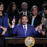 Florida Gov. Ron DeSantis asks if anyone in the audience wants a marker after signing various bills during a bill signing ceremony at the Coastal Community Church at Lighthouse Point, Tuesday, May 16,