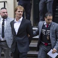 Daniel Penny, center, is walked by New York Police Department detectives out of the 5th Precinct on May. 12, 2023, in New York.