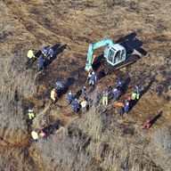 In this Dec. 8, 2011 photo, investigators use a backhoe to dig while searching for Shannan Gilbert's body in different sectors of a marsh area just east of Oak Beach, N.Y. A Long Island architect has
