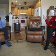 Democrat Jim Carpenter, left, and Republican Natalie Abbas talk as they wait to watch the inauguration of President Joe Biden at Carpenter's apartment in Frederick, Md., on Wednesday, Jan. 20, 2021.