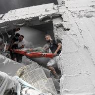 Palestinians carry an injured man out of the destruction following Israeli airstrikes on Gaza City, Friday, Oct. 27, 2023.