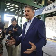 West Virginia Democratic Sen. Joe Manchin speaks with reporters outside the newly renovated Amtrak train station in Charleston, W.Va. on Thursday, Oct. 12, 2023