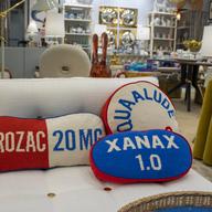 Pillows that look like a Prozac pill, a Xanas pill and a Quaalude pill are on display at a Jonathan Adler store in the American Dream shopping mall in East Rutherford, New Jersey, on Friday, October 6