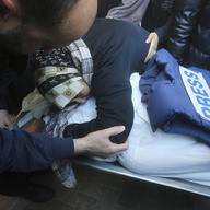 A relative mourns Palestinian journalist Akram Al-Shafi'i, killed in the Israeli bombardment of the Gaza Strip, in a morgue of the European Gaza Hospital in Rafah, Jan. 6, 2024.