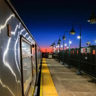 The sunset is seen from the platform of a subway train station in Rockaway in the Queens borough of New York on February 14, 2024. 