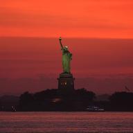 A view of the Statue of Liberty seen from New Jersey, United States as a dangerous heat wave sweeps across the region on June 23, 2025.