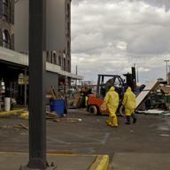 Workers in hazmat suits continue to clear spoiled food and ruined equipment at Fairway in Red Hook Friday.