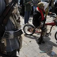 ibyan rebels wait at a checkpoint in Brega, 240 kms (150 miles) south of Benghazi, on March 30, 2011