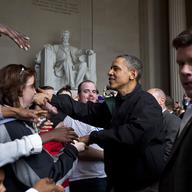 President Barack Obama shakes the hands of tourists visiting the Lincoln Memorial during a surprise visit a day after budget negotiations with Congress prevented a government shutdown April 9, 2011