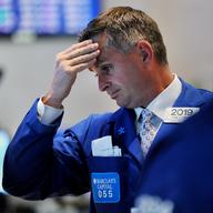 A trader reacts to the market downfall on the floor of the New York Stock Exchange at the closing bell August10, 2011.