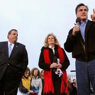 Former Massachusetts Governor and Republican presidential candidate Mitt Romney (R) addresses a campaign rally with his wife Ann Romney (C) and New Jersey Governor Chris Christie at a Hy Vee supermark
