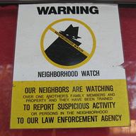 A neighborhood watch sign attached to a door.