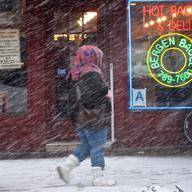 Neon invites New Yorkers in for a hot bagel in Brooklyn as the snow falls.
