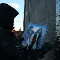 A painter from Colossal Media dangles 150 feet above the Soho streets, painting part of a 6-story Adidas ad.