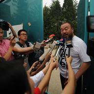 Outspoken Chinese artist Ai Weiwei speaks to reporters outside his studio in Beijing on June 23, 2011.