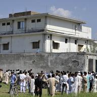Pakistani media personnel and local residents gather outside the hideout of Al-Qaeda leader Osama bin Laden following his death by US Special Forces in a ground operation in Abbottabad on May 3, 2011.