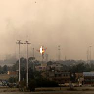 A Libyan jet bomber crashes after being hit over Benghazi on March 19, 2011 as Libya's rebel stronghold came under attack.