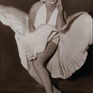 Arguably the most recognized costume in Hollywood film history: Marilyn Monroe in her ivory pleated “Subway” dress by Travilla, in <em>The Seven Year Itch.</em>