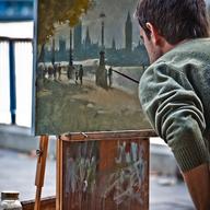 man painting on easel