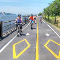 At Riverside Park, bikers are surrounded by the scenes of New York City.