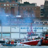 NEW YORK - JANUARY 15: Rescue workers in boats assist a US Airways plane (R) floating in the water. (Photo by Mario Tama/Getty Images)
