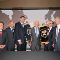 District Attorney Cy Vance, former District Attorney Robert Morgenthau and members of the American Joint Jewish Distribution Committee with the Torah scrolls